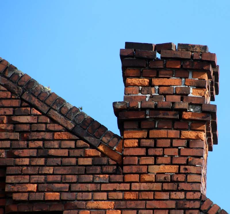 Damaged chimney on an Lancaster home showing cracks and missing mortar
